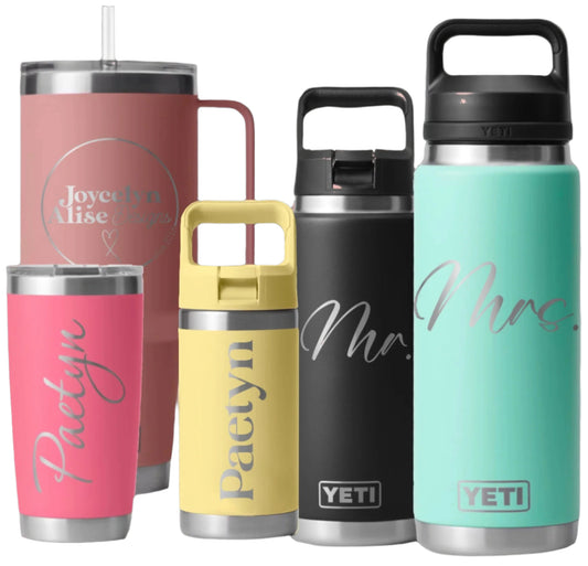Collection of personalized YETI tumblers with names on a pink background